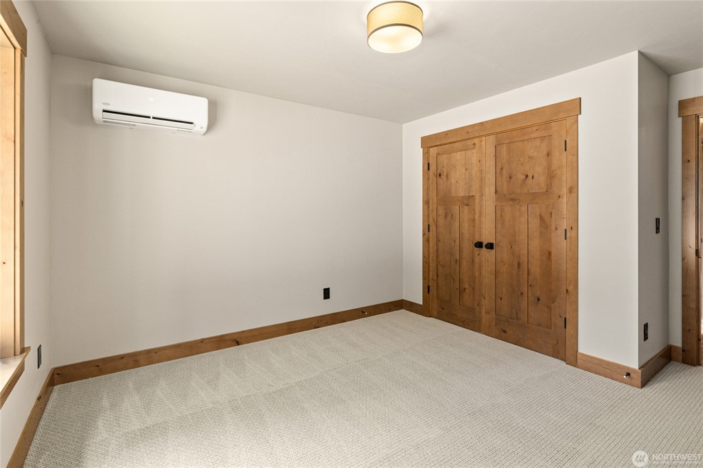 Secondary bedroom with wood closet doors
